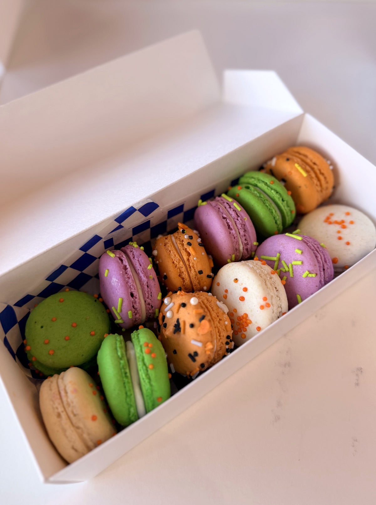 Twelve Halloween macarons in a box